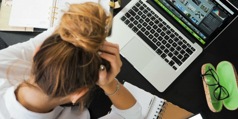 woman sitting in front of macbook